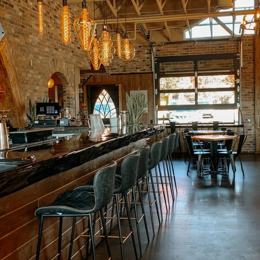 The long bar and arched windows inside the Monkless Belgian Ales Brasserie in Bend