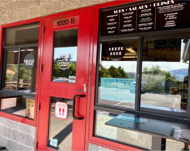 The red front doors of New York City Sub Shop in Bend