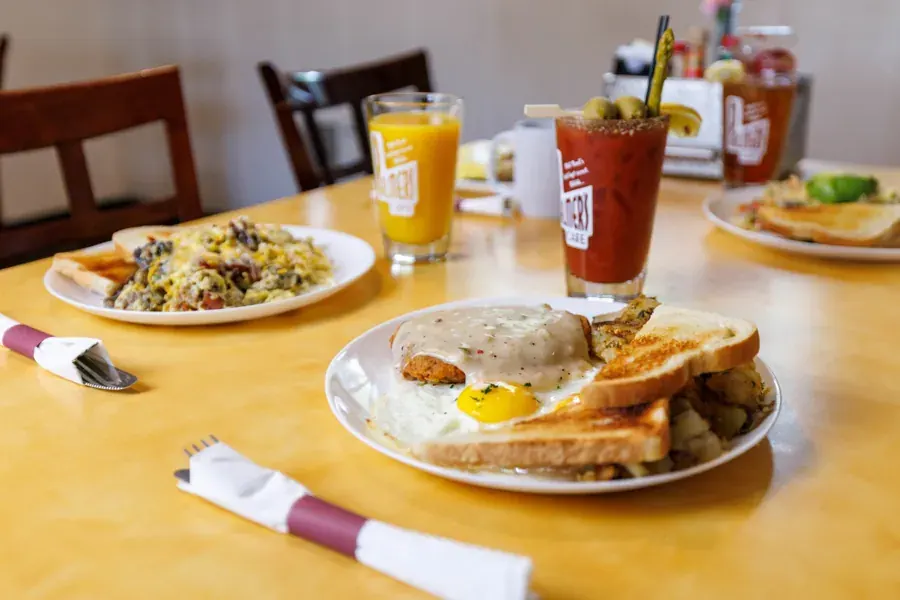 Breakfast plates, juice and a Bloody Mary on a table at Palmer’s Cafe in Bend