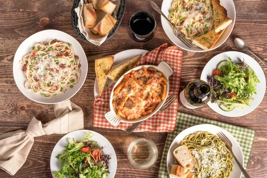 A Pastini table spread of pastas, salads and lasagna