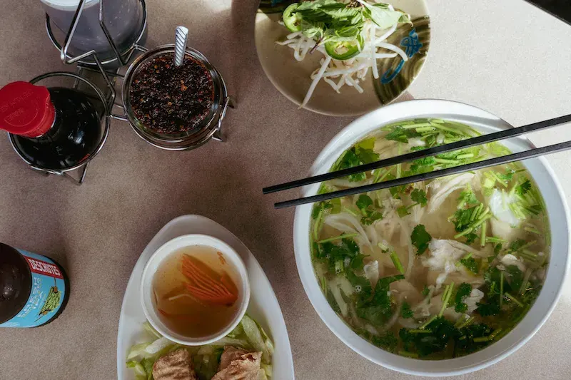 A bowl of pho with herbs and sauces at Pho Viet & Cafe on 3rd Street in Bend