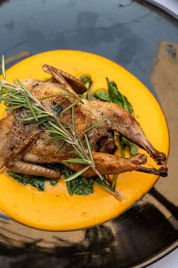 A roasted bird with rosemary on squash puree at Rosemary & Fox in downtown Bend
