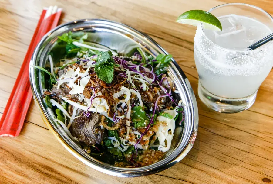 A rice bowl and a margarita on the table at Spork on Newport Avenue in Bend