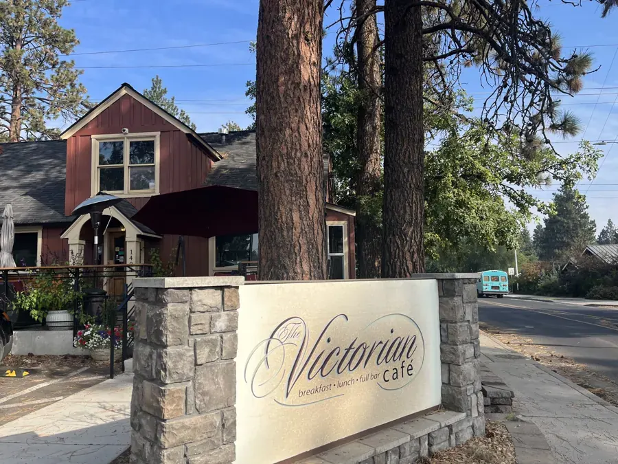 The stone sign and house at The Victorian Café on Galveston Avenue in Bend