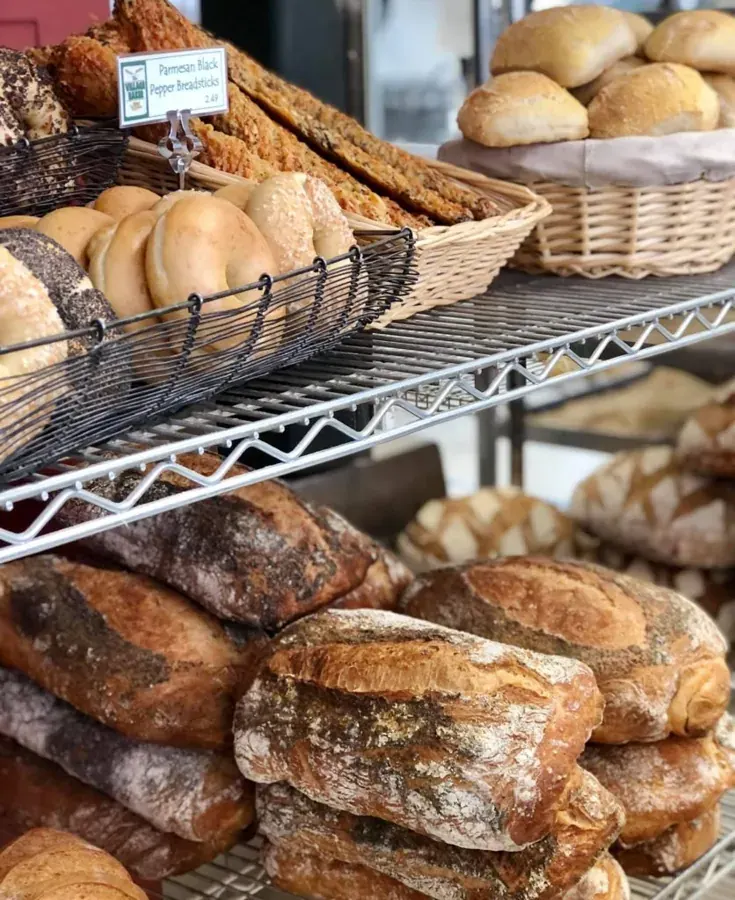 Shelves of fresh bread and rolls at The Village Baker in Bend