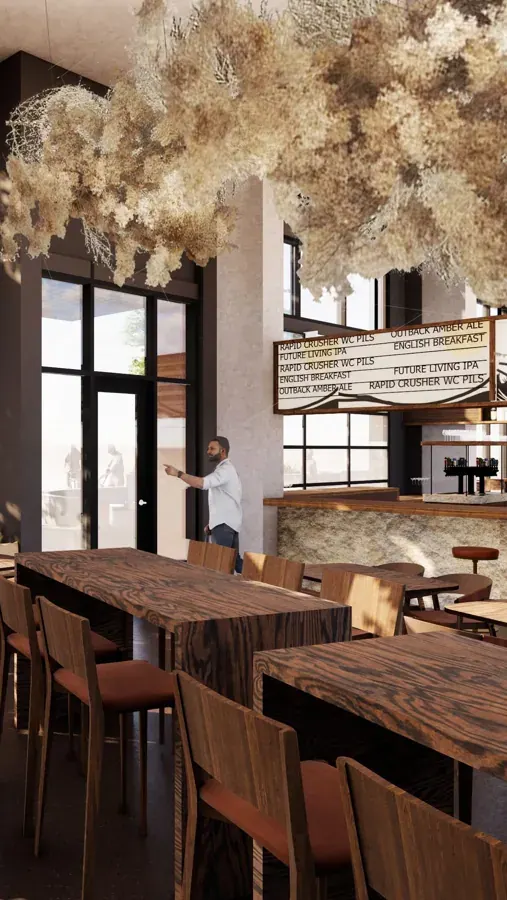 Wood tables and a chandelier in the dining room at The Way West in Bend