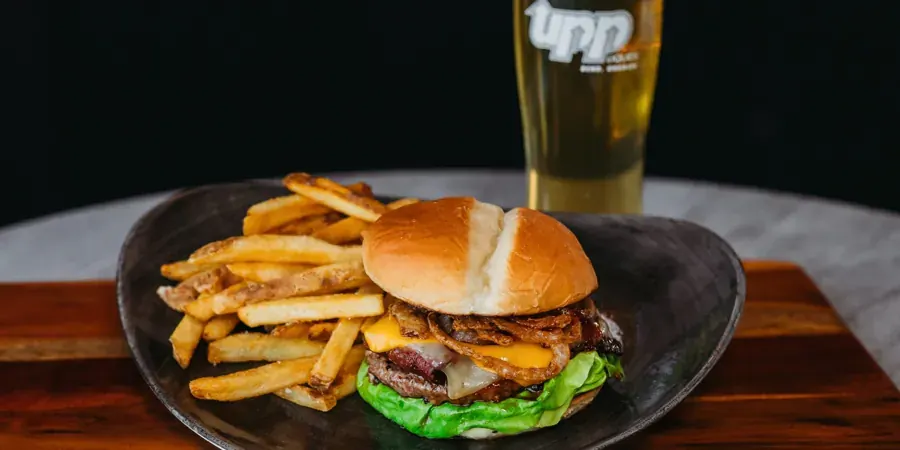 A burger with fries and a beer at UPP Liquids in the Box Factory, Bend