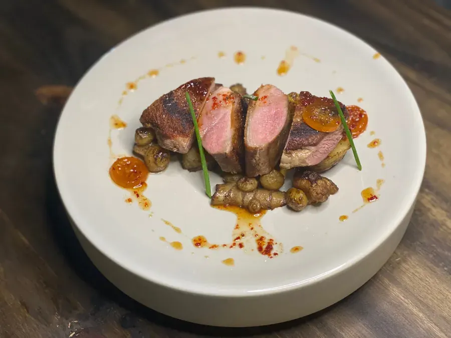 Sliced duck breast on a white plate at Yoli, a Korean restaurant in downtown Bend