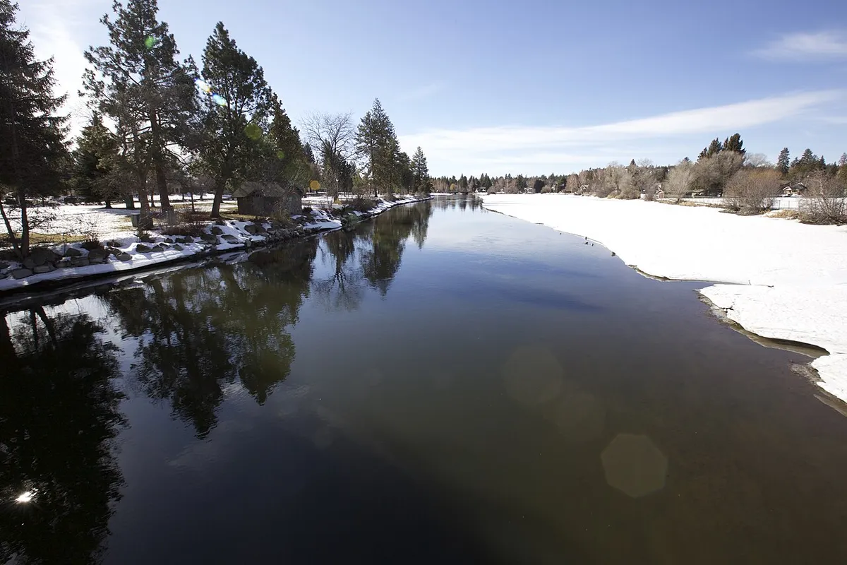 The Deschutes River in Bend with snow on the banks