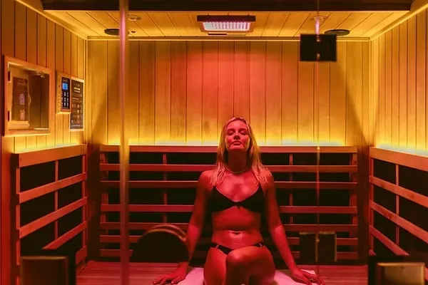 A full-spectrum infrared sauna glowing red at PeakMD Health in Sisters