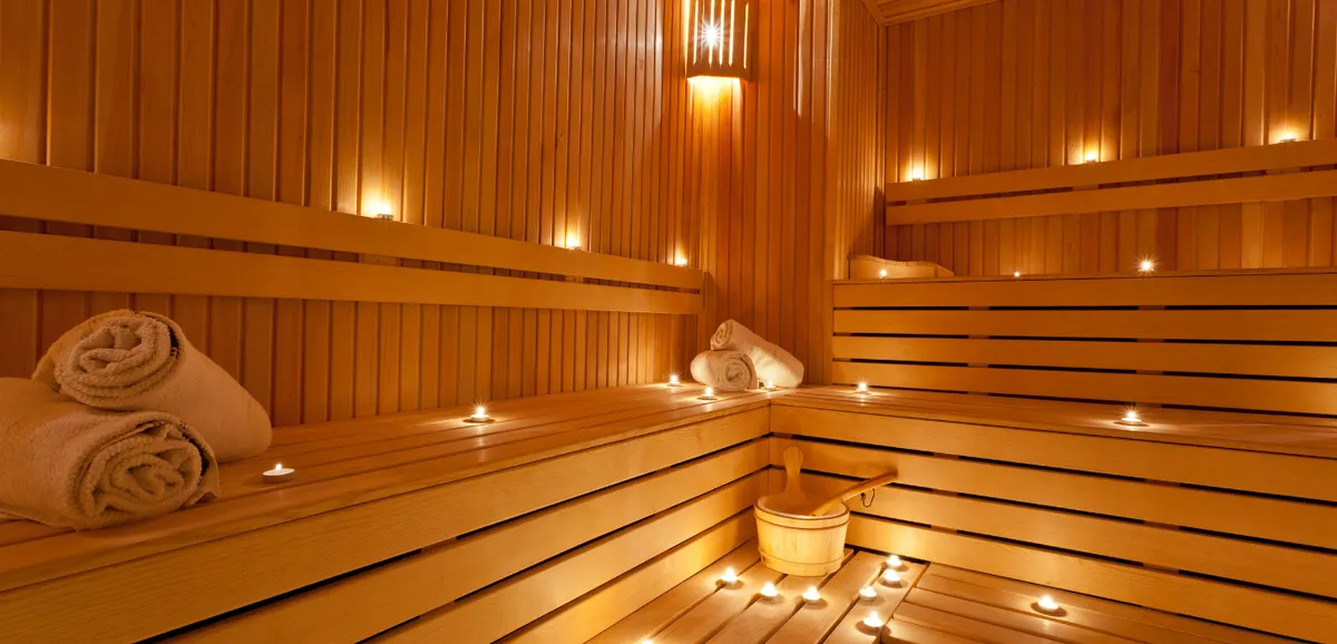 A warm-lit sauna room at RISE Modern Wellness