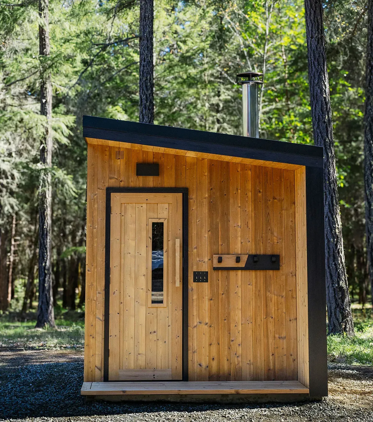 A cedar cabin sauna in a pine forest by Rogue Sauna