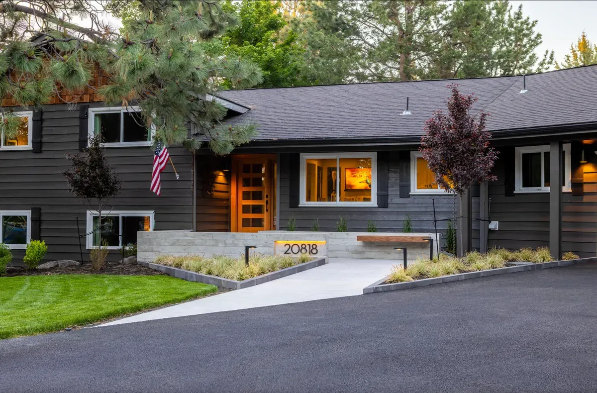 A green front lawn and landscaped yard in front of a Bend home