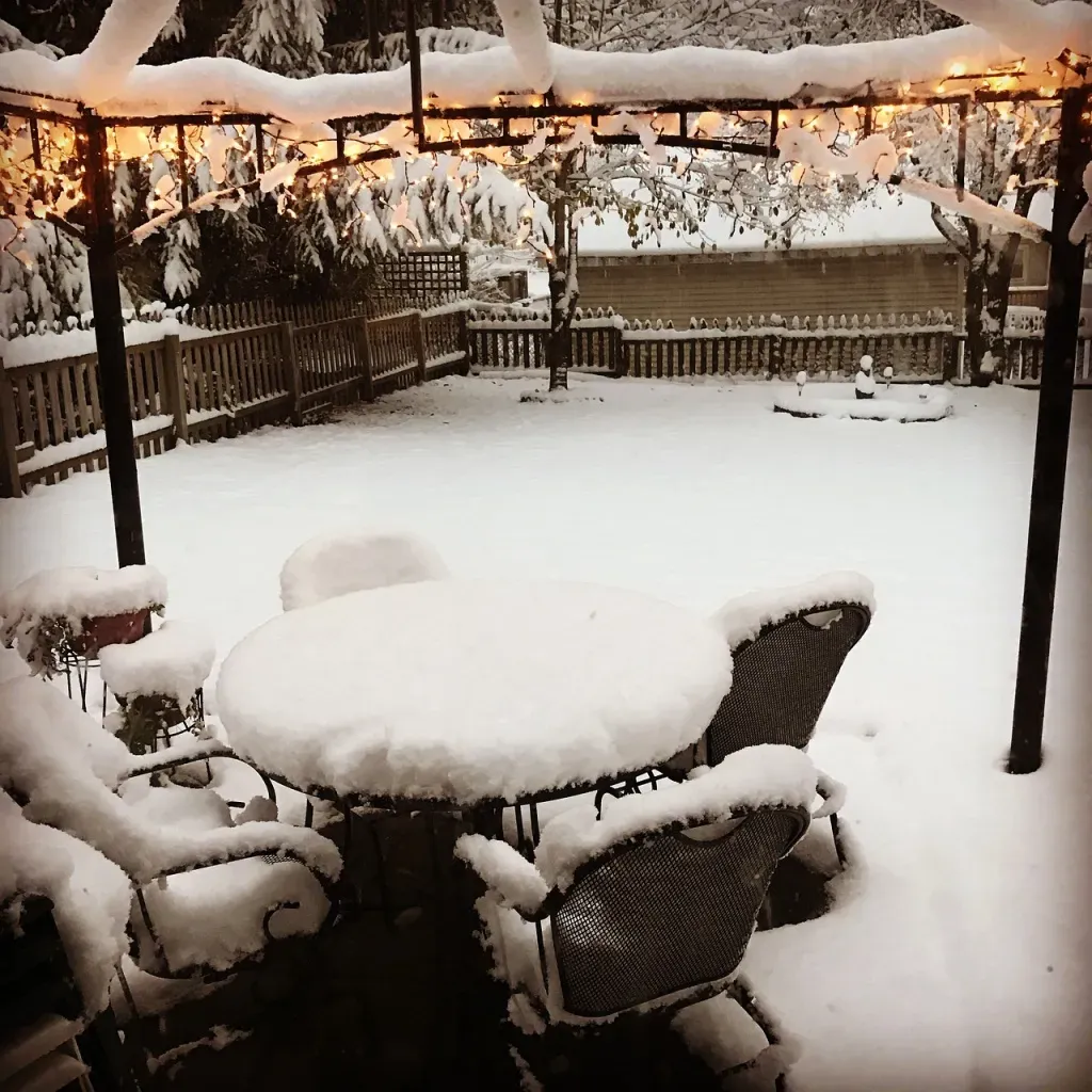 A snow-covered patio and table in Sisters, Oregon