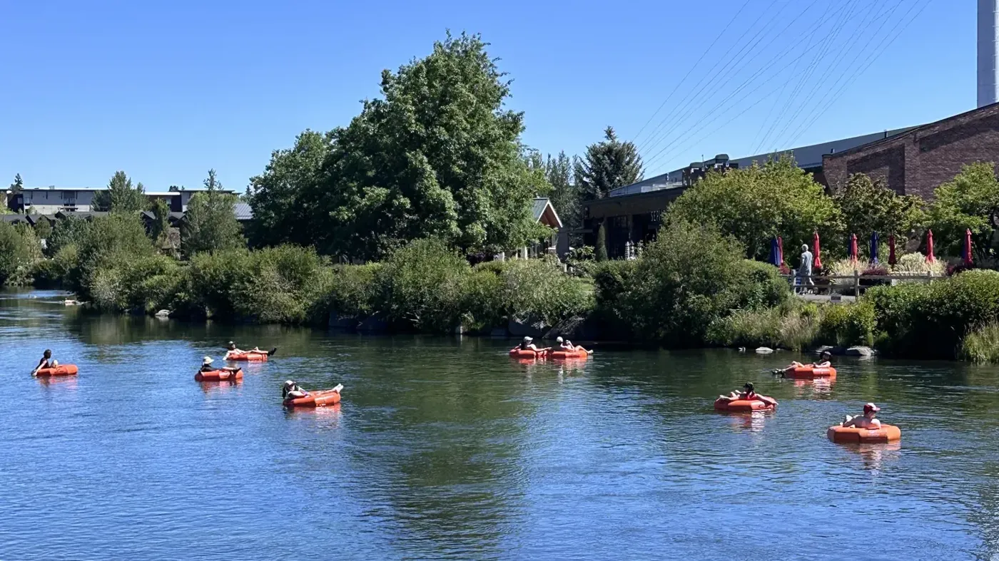 People floating the Deschutes River on inner tubes on a sunny summer day in Bend