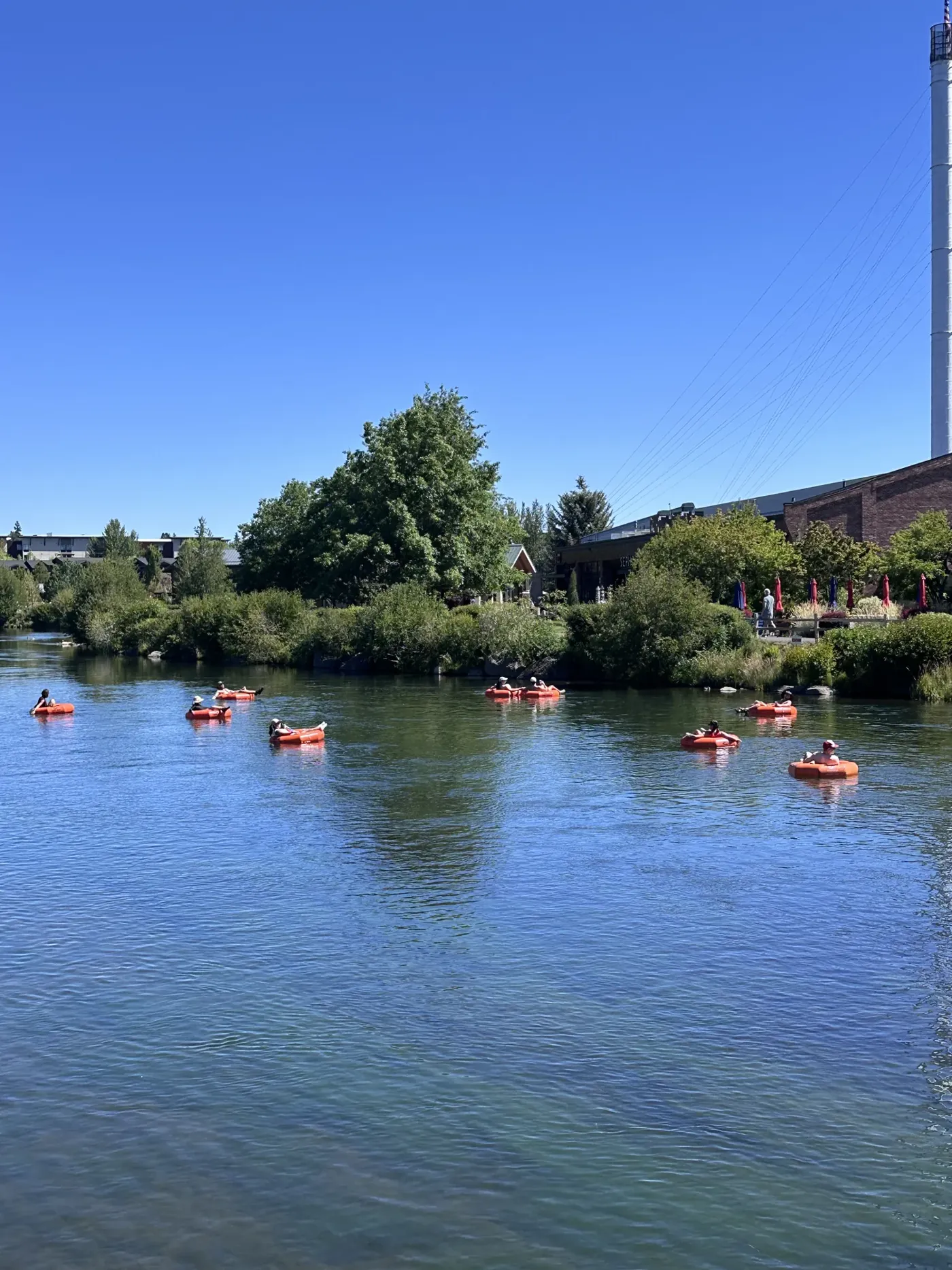 Floaters and kayakers on the Deschutes near the Old Mill District