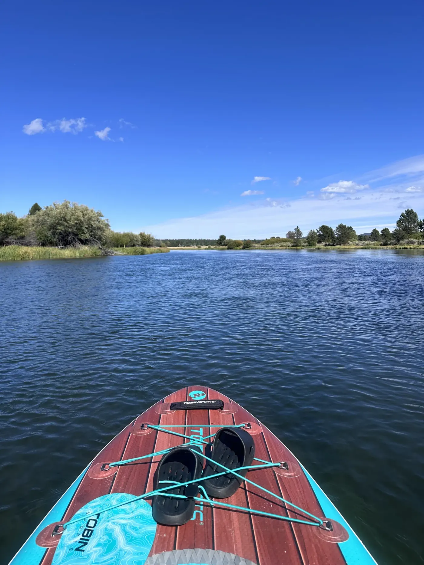 A paddleboard on the calm Deschutes River in Sunriver