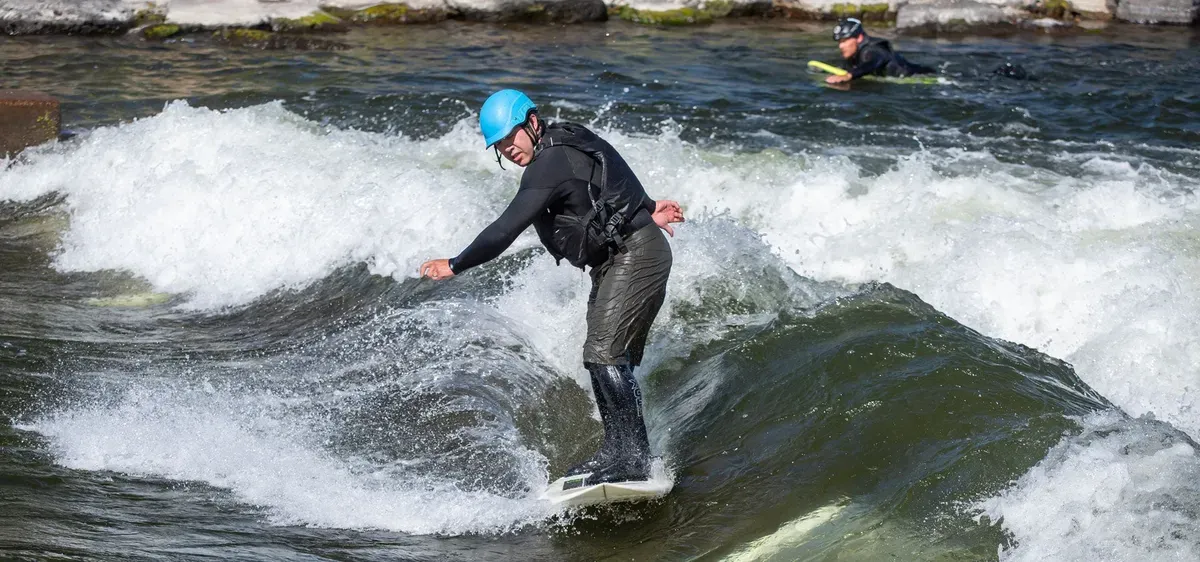 A surfer riding a standing wave at the Bend Whitewater Park